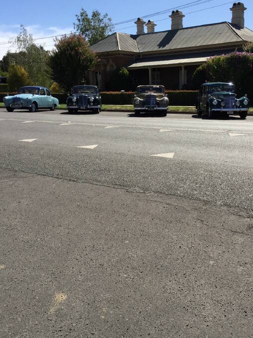 Gorgeous vintage cars line up on the main street
