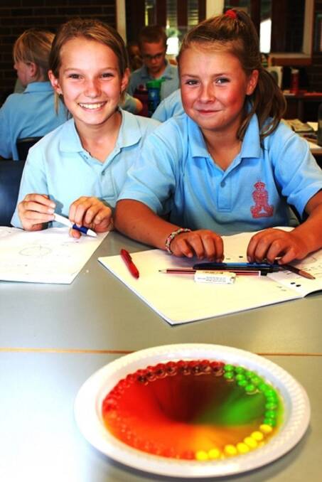 COLOURFUL: Year 5 are currently examining light and colour in their science classes this term. Students enjoyed hands on experiments including mixing colours from skittles.Brianna Roberts and Kimberly Allport are pleased with their experiment.