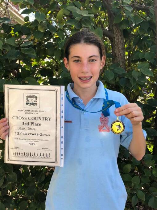 All smiles: Lilly Skelly stands with her medal and certificate from the regional cross country competition. Photo: Crookwell Public School.