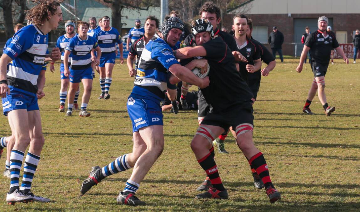 Grapple: The Dogs and the Redbacks produced a classic game, full of momentum swings and surprises at the Crookwell Memorial Oval last Saturday. Photo: Gordon Waters. 