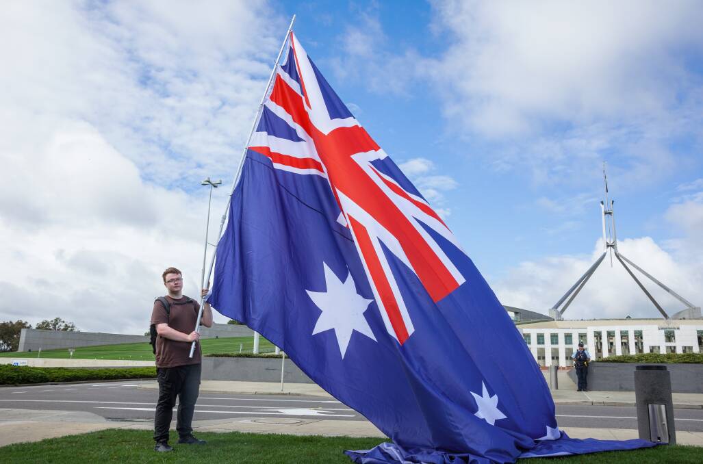 Zach Hook (above) and his flag at the demonstration. (Below) Ian Menzies. Pictures by Sitthixay Ditthavong