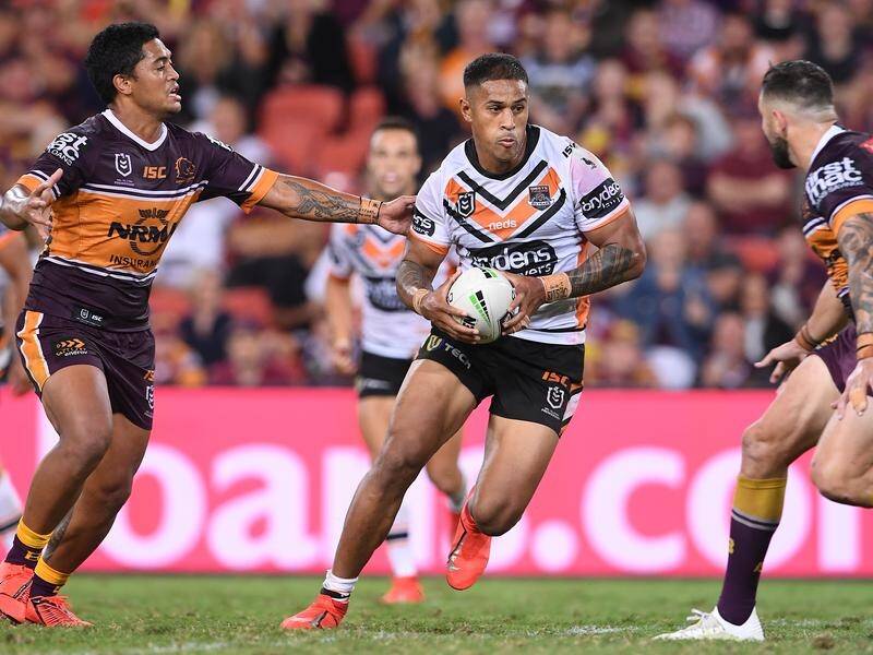 Michael Chee Kam has been stood down by the Wests Tigers after pleading guilty to assault.
