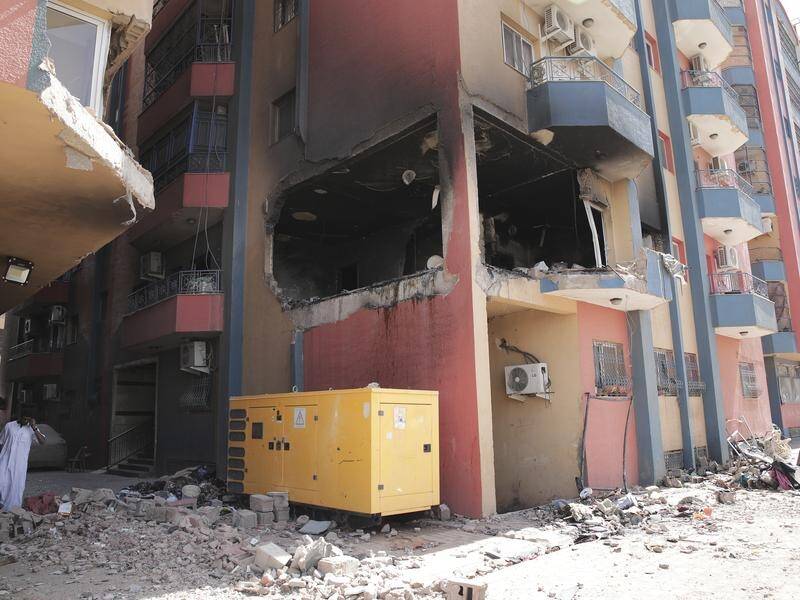 Shells have torn gaping holes in buildings in Sudan's capital Khartoum amid fierce clashes. (AP PHOTO)