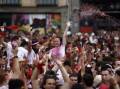 Thousands of revellers have erupted in celebration at the start of the San Fermin bull-run festival.