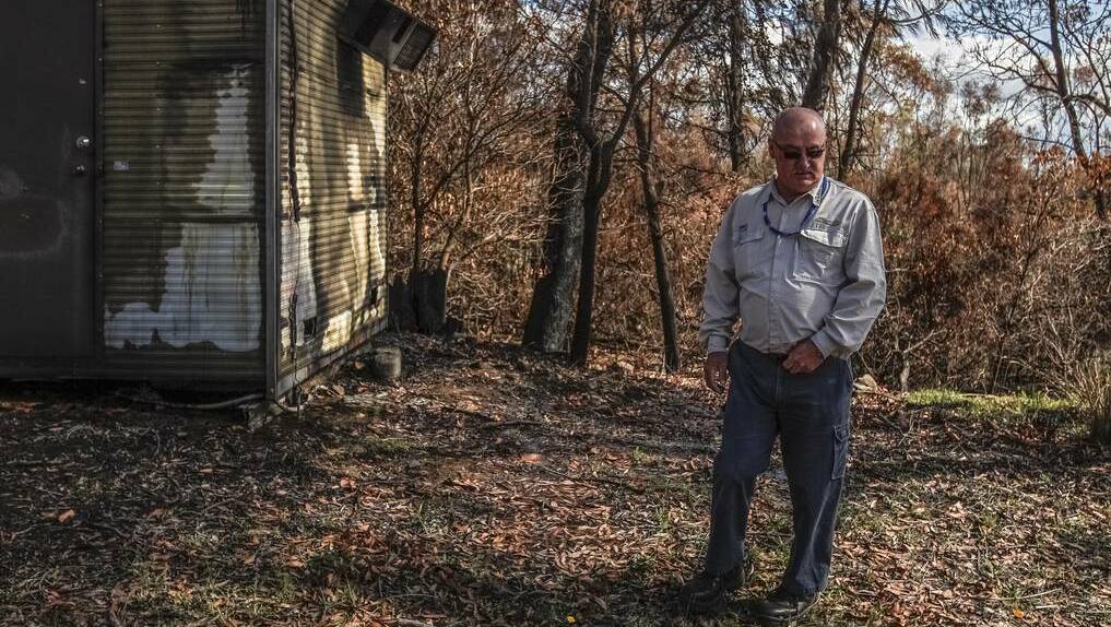 Sydney Catchment Authority’s Shane Muldoon in front of a burnt-out shed at the filtration plant. Photo: CHRISTOPHER CHAN