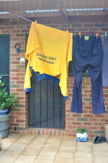 Former Taralga Rural Fire Brigade Captain Mick Chalker's uniform hangs on the line at his Wombeyan Caves home after fighting the fires consistently for two weeks. Photo: Hannah Sparks