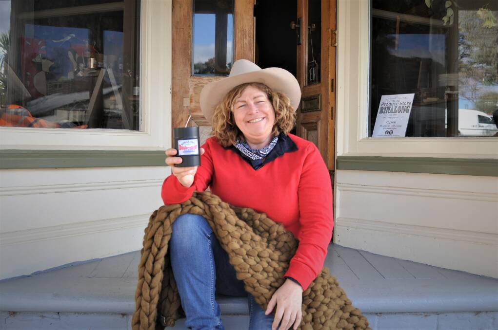 Open for business: Cathy Kerslake outside The Old Produce Store Binalong with a mandle and rug available for purchase. Photo: Hannah Sparks 