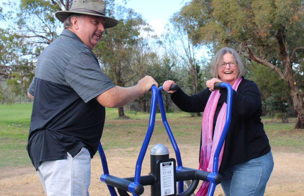 SWING OF IT: Collector Community Association secretary Gary Poile and Christine Lovelock try out the new fitness equipment in Collector. Photo: Chris Gordon