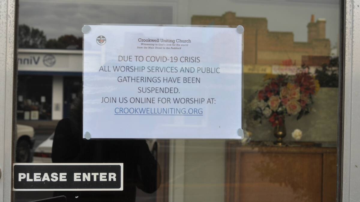 A sign on the door at Crookwell Uniting Church letting members know its worship services are cancelled during the coronavirus pandemic. Photo: Hannah Sparks