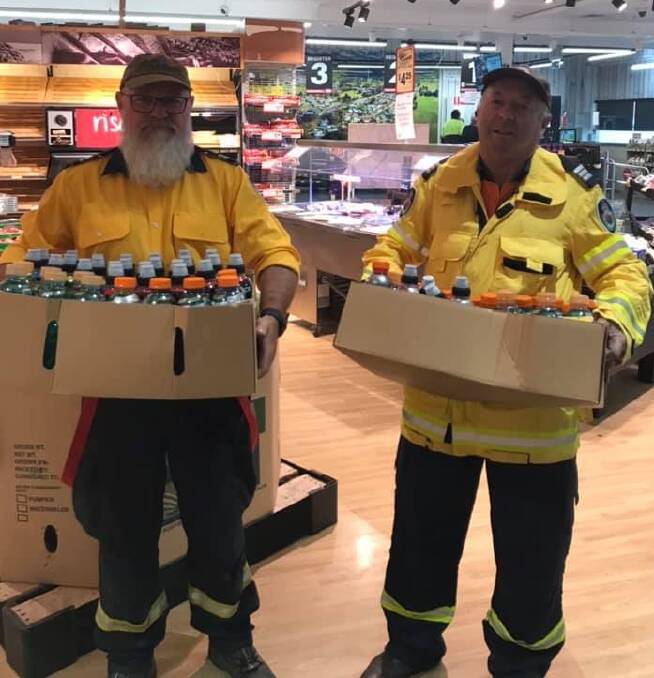 BUSHFIRE APPEAL: Richard Gay and Rob Harrison of the NSW Rural Fire Service collect items donated by Crookwell IGA. Photo: supplied